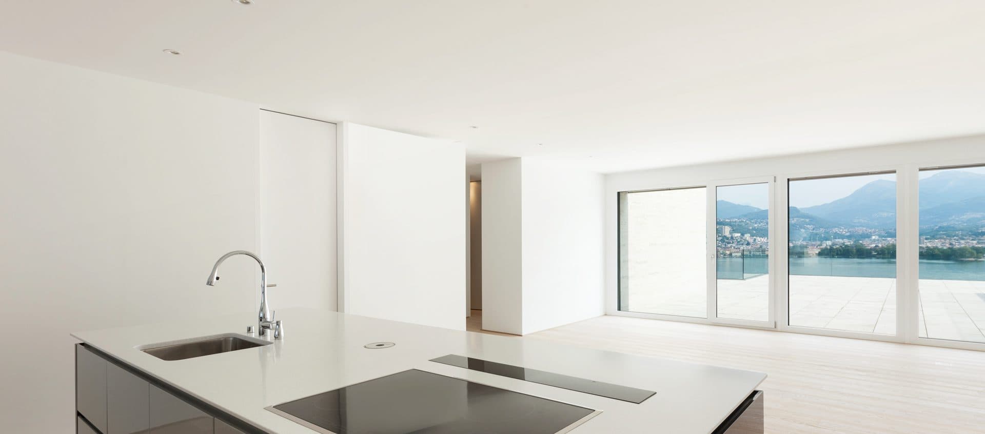 Bright open-plan kitchen with a large glass front